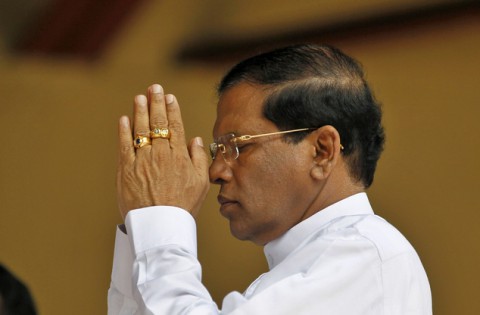 Former Sri Lankan Health Minister and presidential candidate of the common opposition Maithripala Sirisena prays during an event in Colombo, Sri Lanka, Monday, Dec. 1, 2014. Sirisena on Monday signed an agreement with opposition parties, trade unions and professional groups to scrap the country's powerful presidential system and carry out other democratic reforms if he beats incumbent Mahinda Rajapaksa and wins January's presidential election. (AP Photo/Eranga Jayawardena)